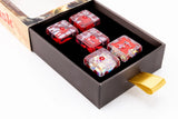 Red and clear cube-shaped objects in a box with a visible brand name.