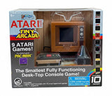 ATARI Tiny Arcade 2800 toy game console in retail packaging, showing a miniature wood-look TV, controller, and accessories through a clear front window.