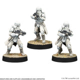 Three stormtrooper miniatures on stands with a white background