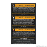 A product packaging insert for 'Han Solo & Chewbacca' miniatures by Atomic Mass Games, featuring three sections of bilingual English and Spanish text on a black background with orange headers.