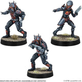 Three miniature figures of a character in futuristic armor on black bases with grass texture.