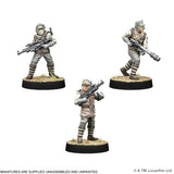 Three miniature figures of soldiers in tactical gear on a white background