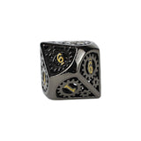 Black metal dice with gold numbers on a white background