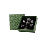 Set of silver dice in a green box with geometric pattern