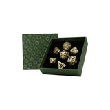 Gold dice set in a green box with geometric pattern