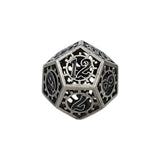 Decorative metal dice with intricate designs on a white background
