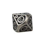 Metallic die with gear design on a white background