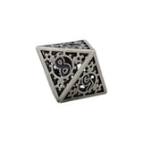 Decorative silver cube with intricate patterns on a white background