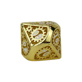 Gold metal dice with gear design on a white background
