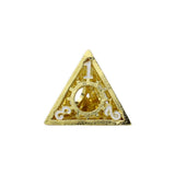 Gold triangular brooch with a central circular design on a white background