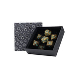 Set of decorative dice with gold and blue patterns in a black box with geometric patterned lid.