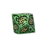 Green polyhedral dice with black and gold numbers on a white background