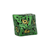 Green die with gold numbers on a white background