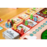 Board game with colorful pieces and cards on a wooden table