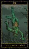 Tarot card featuring a green humanoid figure hanging from a noose underwater, labeled 'The Hanged Man'.