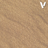Close-up of sand with a visible brand logo in the corner