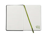 Open notebook with a green strap on a white background