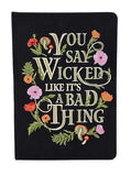 Black notebook with embroidered text and floral designs on a white background