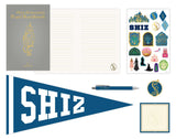 Collection of 'SHIZ' branded stationery items including a notebook, pennant, pen, and stickers.