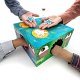 Box Monster. A demo where 2 people are reaching into the open sides, that look like monster mouths, and the 2 hands in the back each have a blue starfish. Completed on top is 2 game pieces and a small hour glass.